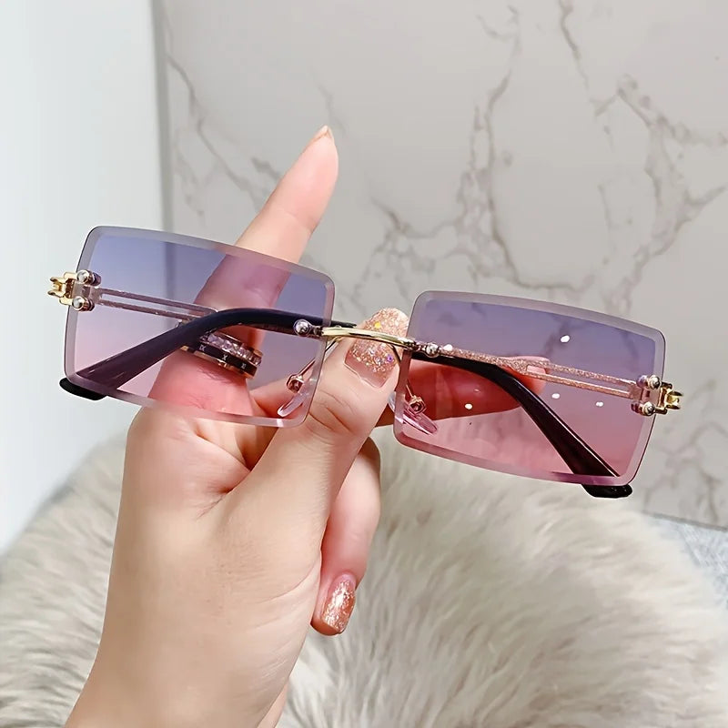 rimless, rectangular sunglasses with a brown gradient tint and decorative metal hinges.