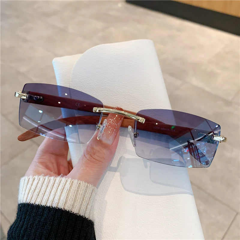 rimless square sunglasses with a gold-tone metal frame and temples.