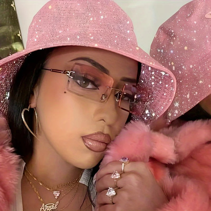 rimless, rectangular sunglasses with a brown gradient tint and decorative metal hinges.