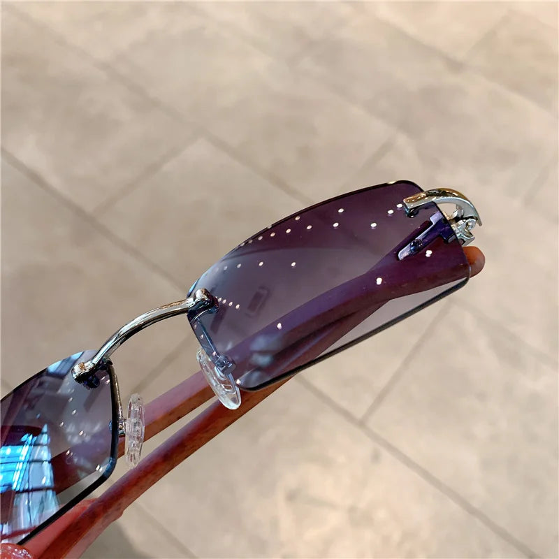 rimless square sunglasses with a gold-tone metal frame and temples.